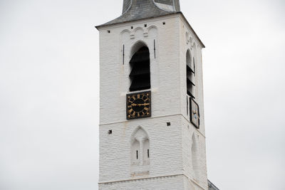 Low angle view of clock tower against sky