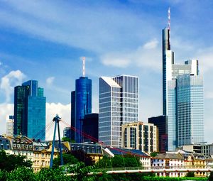 Modern buildings against cloudy sky