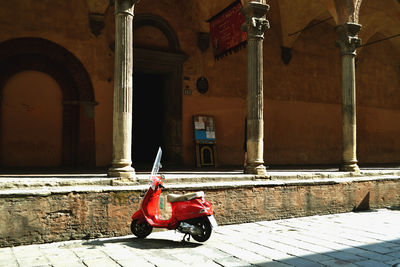 Motorcycle on road against building