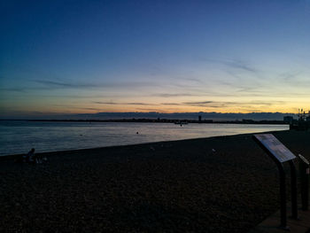 Scenic view of beach against sky during sunset