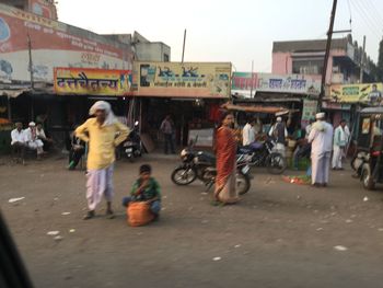 Man standing on road in city