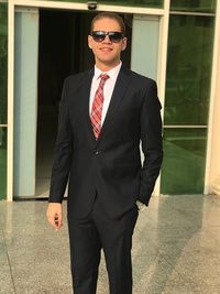 Young man wearing sunglasses standing outdoors