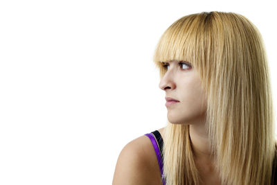 Close-up portrait of a young woman against white background