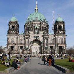 Tourists in front of berlin cathedral against sky