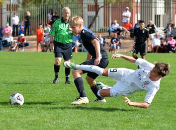 Men playing soccer on field