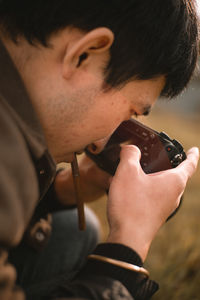 Young man photographing outdoors