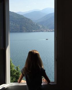 Woman looking at view from window