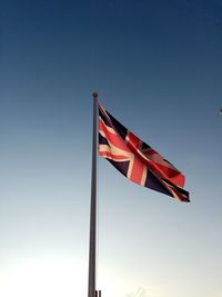 Low angle view of flag flags against clear sky