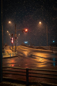 Illuminated street lights in city during winter at night