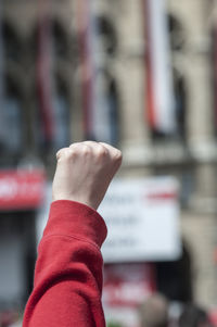 Close-up of person hand holding red text