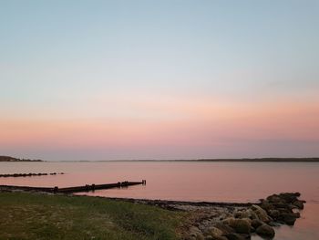 Scenic view of sea against sky at sunset