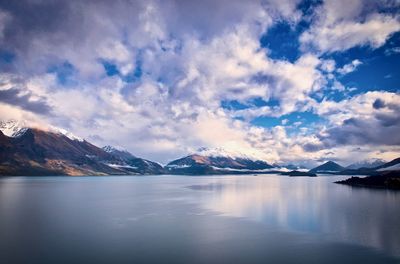 Scenic view of lake and snowcapped mountains against sky