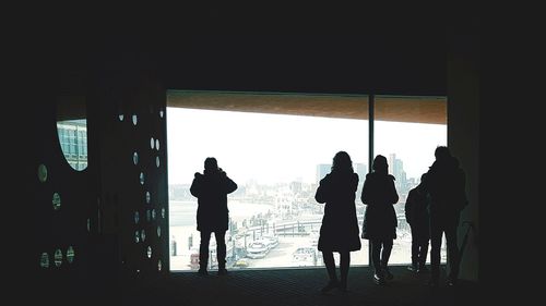 Silhouette people standing in corridor