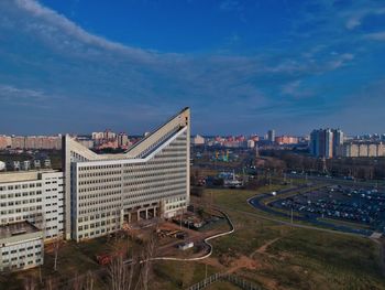 High angle view of buildings against blue sky