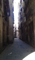 Empty road along buildings