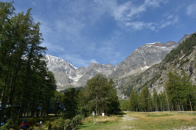 Scenic view of trees and mountains against sky