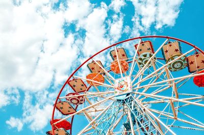 Low angle view of ferris wheel against blue sky