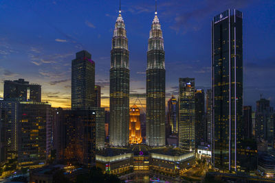Illuminated cityscape against sky at night