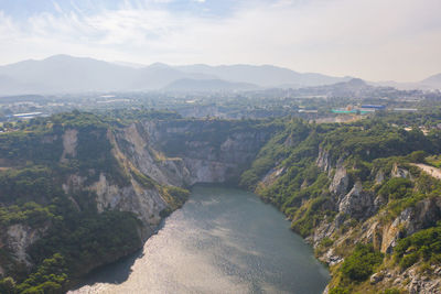 High angle view of river amidst mountains against sky