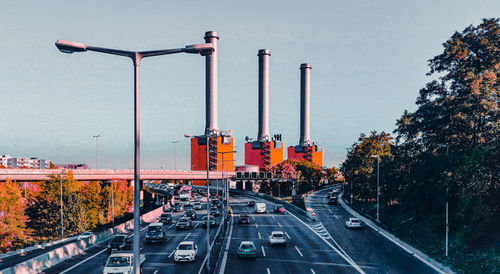 Traffic on road in city against sky