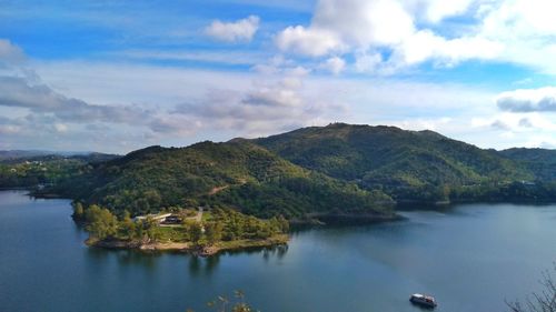 Scenic view of lake and mountains against sky