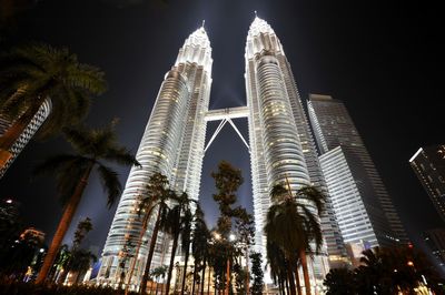 Low angle view of skyscrapers lit up at night