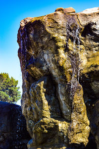 Close-up of rock formation against sky