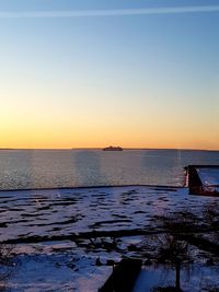 Scenic view of sea against clear sky during sunset