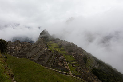 Scenic view of mountain against cloudy sky