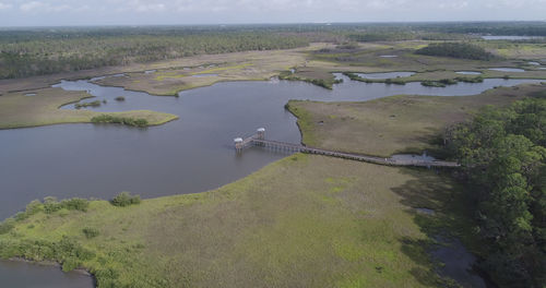 High angle view of river amidst landscape against sky