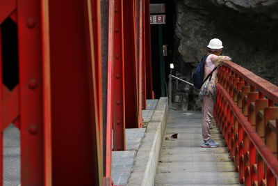 Rear view of man working on staircase