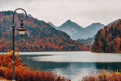 Scenic view of lake by mountains against sky