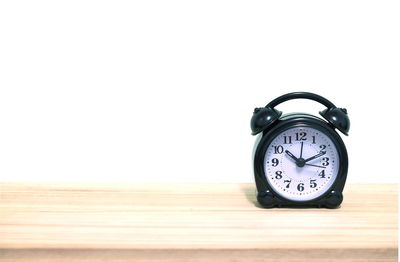 Close-up of clock over white background