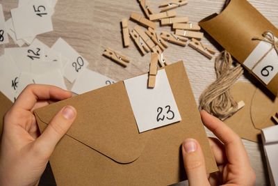 Cropped hand of woman holding paper