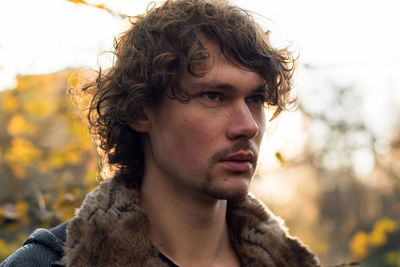 Portrait of young man looking away outdoors