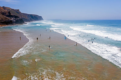 People on beach against sky