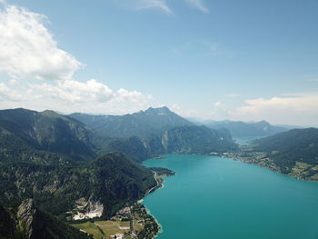 High angle view of sea and mountains against sky