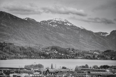Scenic view of river and mountains against sky