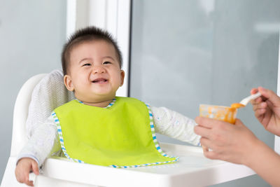 Portrait of cute boy holding baby