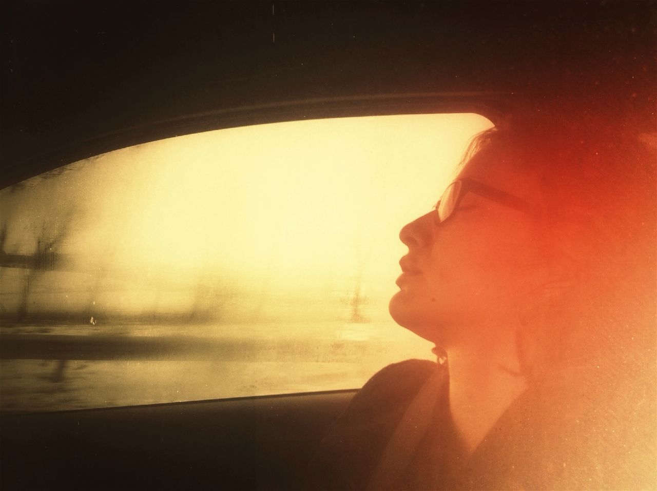 lifestyles, indoors, leisure activity, window, headshot, water, reflection, side view, young adult, part of, young women, holding, vehicle interior, person, glass - material, close-up, sunset