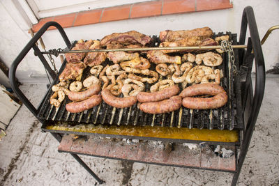 High angle view of meat on barbecue grill