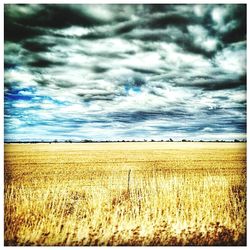 Scenic view of landscape against cloudy sky