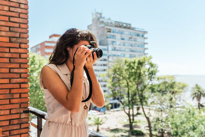 Man photographing against camera