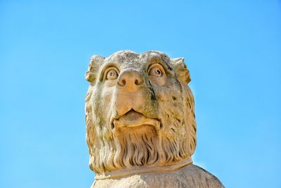 Low angle view of statue against clear blue sky