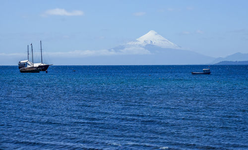 Sailboats sailing in sea against sky