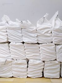 Close-up of white stack on table against wall