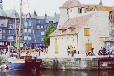 Boats in canal with buildings in background