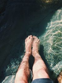Low section of woman on sand at beach