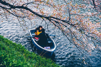 Man sitting on boat in canal