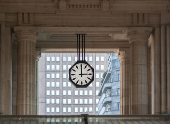 Low angle view of clock on wall